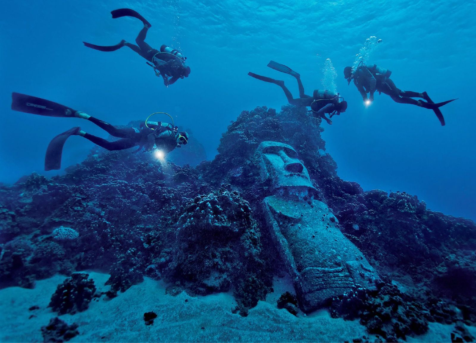 Buzos alrededor de moai sumergido